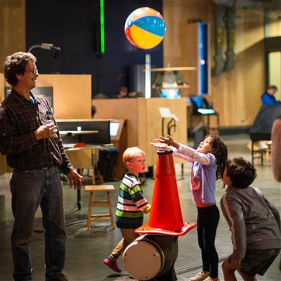 Exploratorium Tinkering Space balancing ball Kids and their dad enjoying the balancing ball at the Exploratorium's The Art of Tinkering