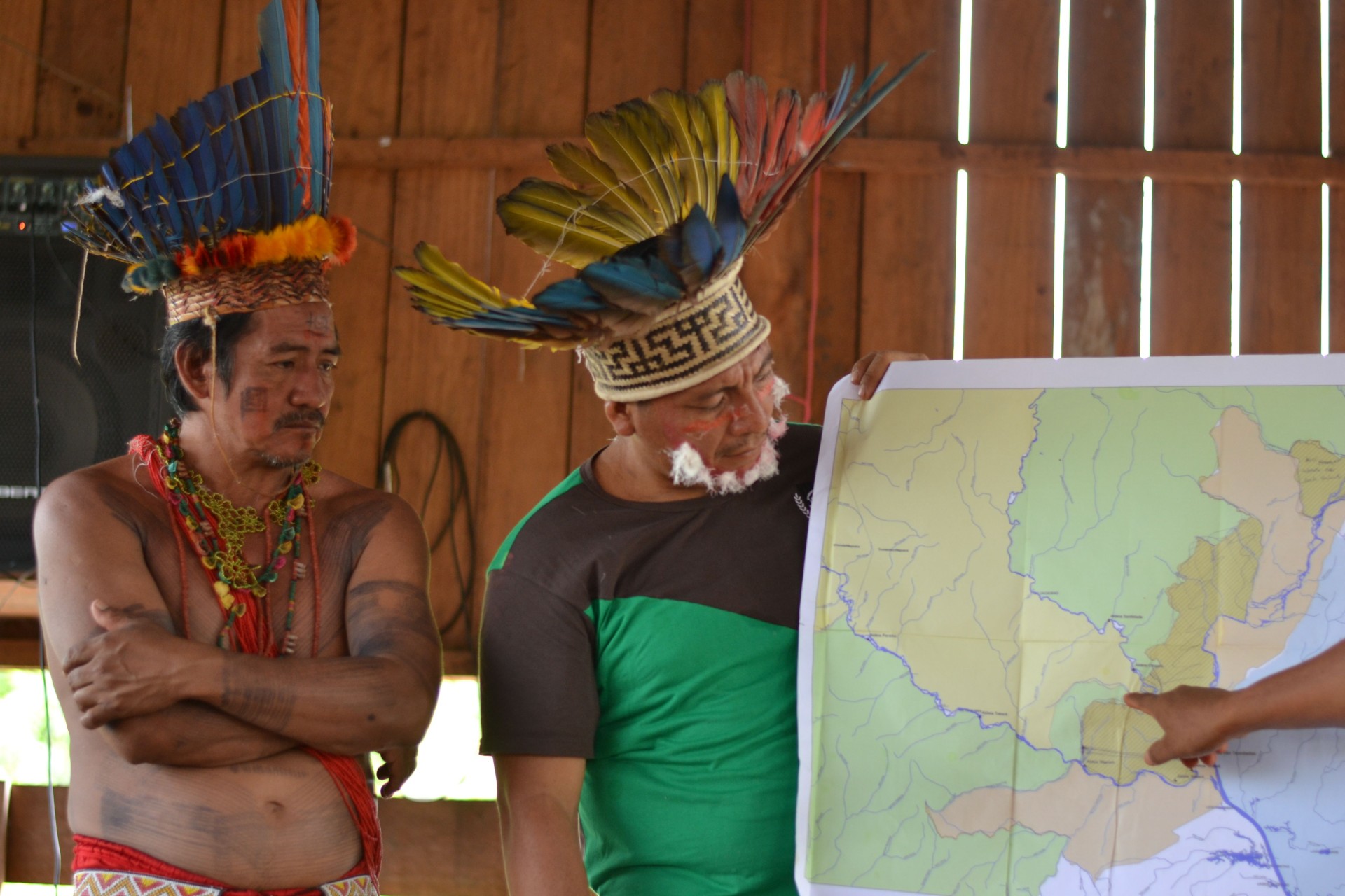 Indigenous leaders Juventino Kaxuyana and Lázaro Tunayana reflecting on maps of the Wayamu territory